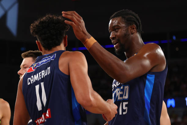 Ariel Hukporti smiles during the Melbourne Derby at John Cain Arena as United fans, marking the thrilling season opener of NBL 2024 on September 28. Image Link: https://www.gettyimages.com/detail/news-photo/ariel-hukporti-of-united-smiles-during-the-round-one-nbl-news-photo/1705778349?adppopup=true